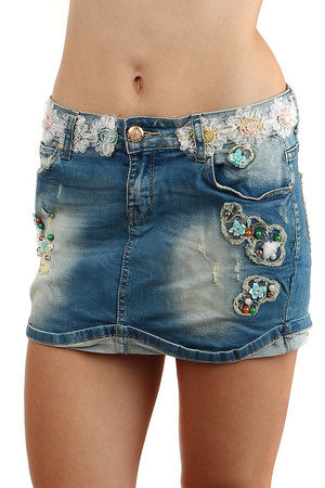 Denim miniskirt decorated with floral application around the waist. Beaded front, back pocket decorated with rhinestones.