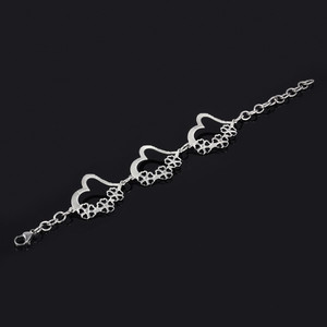 Bracelet made of surgical steel connected by heart. Dimensions: length adjustable 17,5-24cm, width 6mm, heart 38 x 28mm
