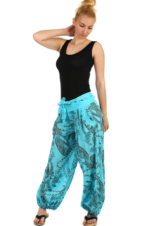 Stylish loose pants with an interesting pattern. Decorated with buttons on the side of the pocket. Tied ribbon at the waist.