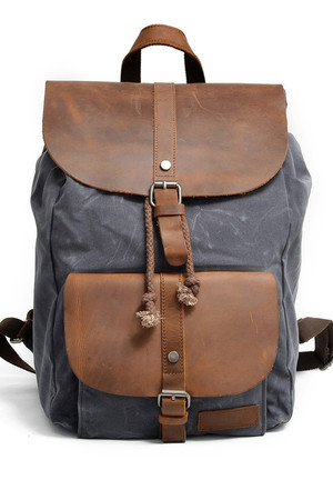Classic unisex backpack a combination of waterproof canvas and genuine leather main pocket with a decorative buckle for