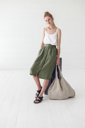 One-color button-down skirt made of 100% linen in a fashionable midi length for girls and ladies of all ages. 5.5 cm high