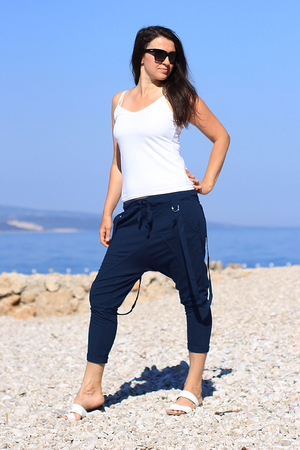 Women's sweatpants in 7/8 length with pockets one color design elastic waist and drawstring at the waist asymmetrical