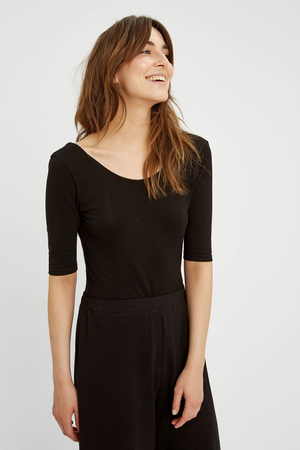 Women's versatile stretch bodysuit from eco-friendly material sustainable fashion English brand PeopleTree sleeves above the