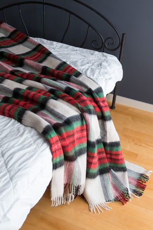 Woollen plaid soft and cosy light and warm 100% wool antibacterial and hypoallergenic Nordic style with fringe around the