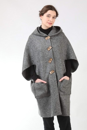 An eye-catching detachable wool hooded poncho monochrome 100% sheep wool sustainable fashion excellent natural properties