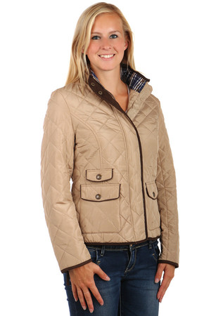 Women's quilted jacket with distinctive front pockets. Zip fasteners and patents. Zippers on the sleeves. Design without