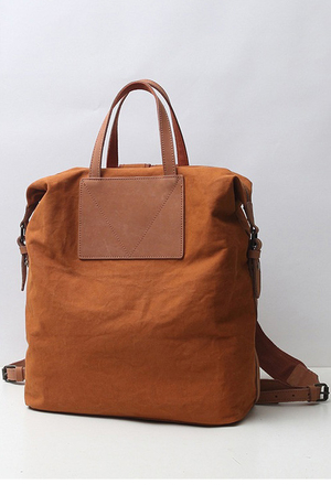 Simple backpack and bag in one in sturdy canvas with leather detailing lined two interior freely accessible pockets one