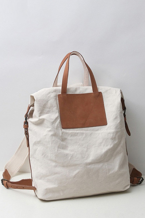 Simple backpack and bag in one in sturdy canvas with leather detailing lined two interior freely accessible pockets one