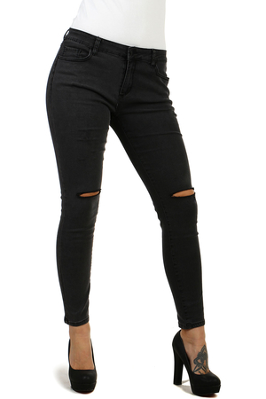 Narrow women's jeans in black with a fashionable tear on the knees and scratches on the thighs. normal waist height narrow