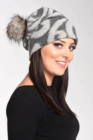Women's warm wool beanie for cold days with ornamental pattern fur pompom striping in the back keeps the fallen shape double