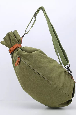 Canvas backpack in army style bag-like shape patent closure, secured with a leather strap and buckle lining inside two inner
