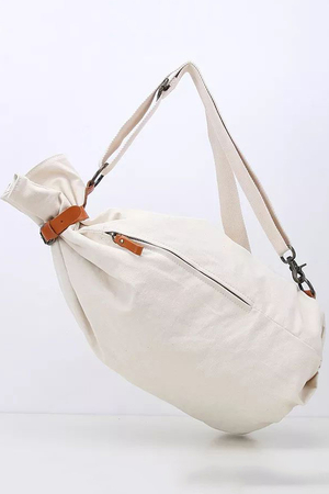 Canvas backpack in army style bag-like shape patent closure, secured with a leather strap and buckle lining inside two inner